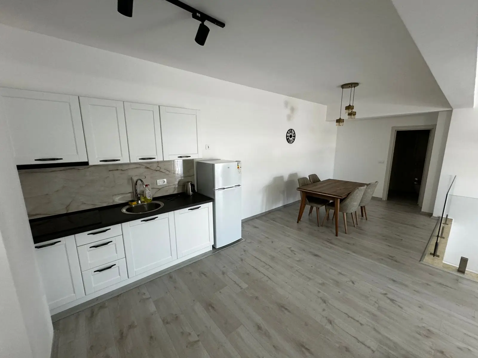 Stunning Ulcinj kitchen with sleek white cabinets, dining nook, and airy design&mdash;exclusive listing on immorenta.me by Ekosphere.