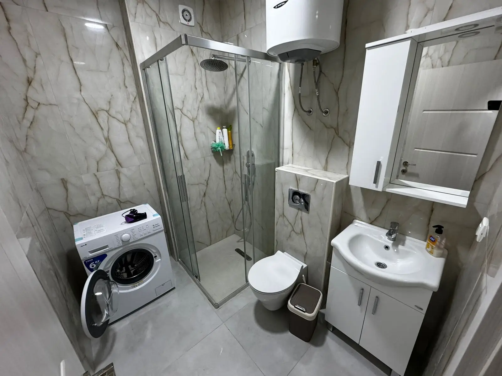 Premium modern bathroom in Ulcinj property: marble walls, glass shower, top fixtures; exclusive at immorenta.me by ekosphere doo.