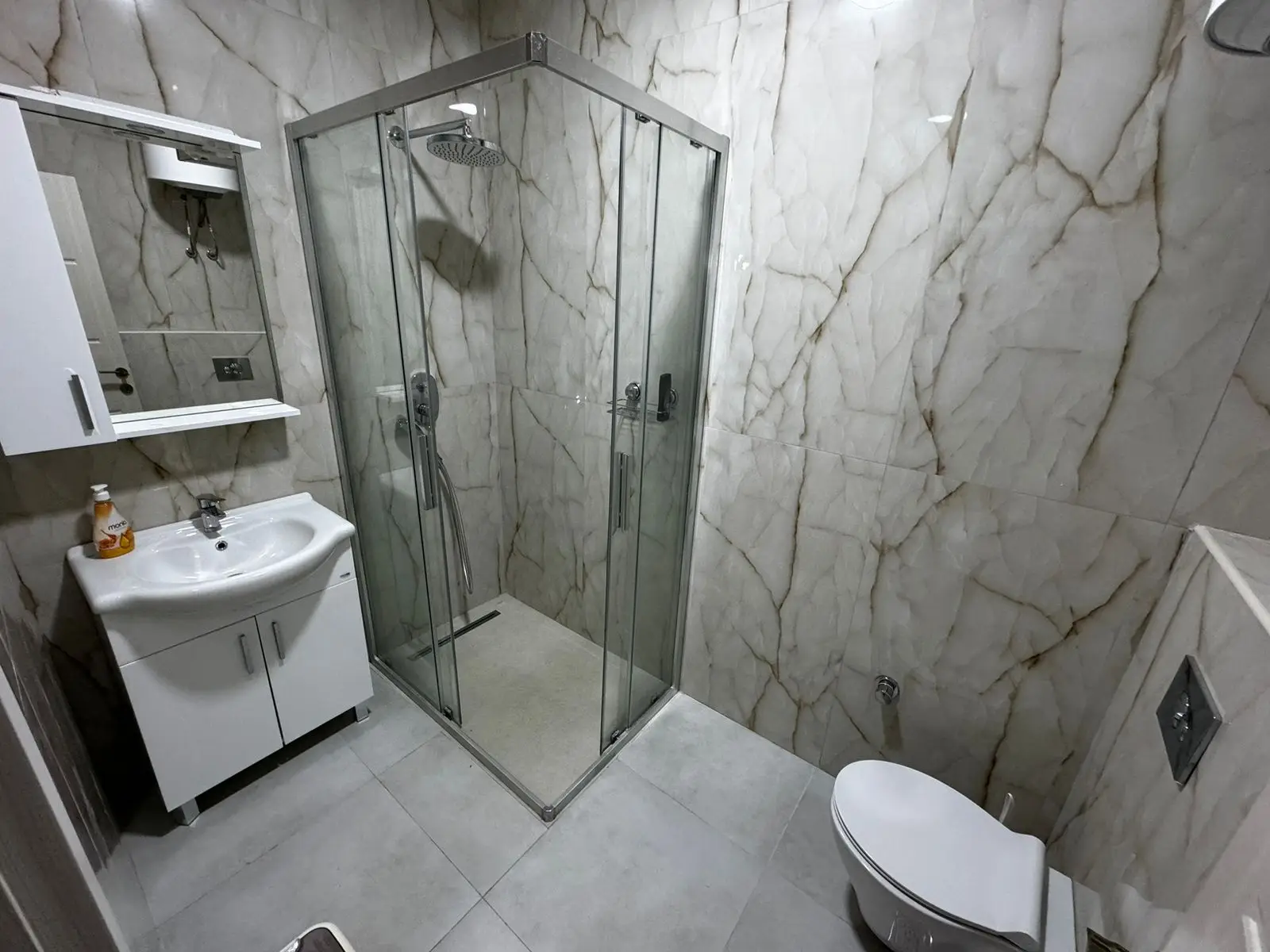 Luxurious Ulcinj property: modern bathroom with marble accents, glass shower, elegant finishes. Invest via immorenta.me Ekosphere.