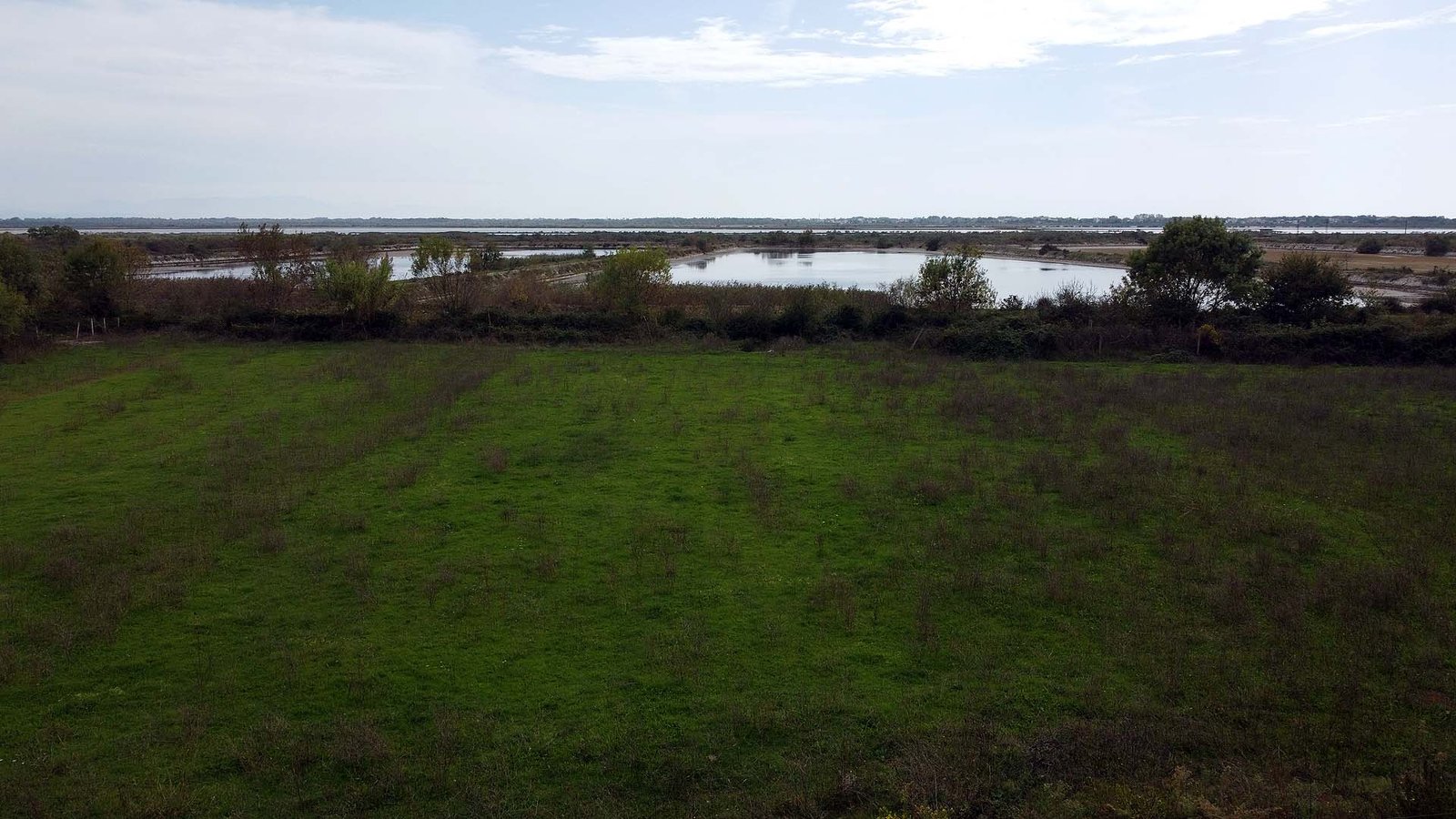 Prime Ulcinj land for sale: lush green fields, pond, scenic views&acirc;exclusive investment on immorenta.me by ekosphere doo.