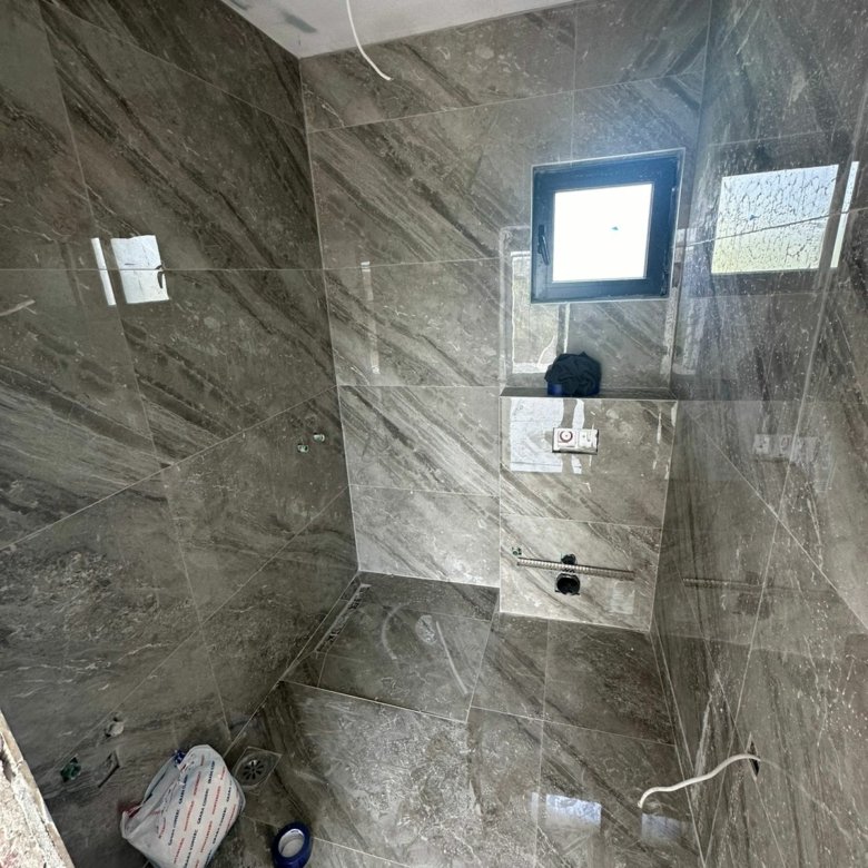 Bathroom under construction in Ulcinj with gray marble tiles&mdash;prime real estate investment via immorenta.me by Ekosphere Doo.