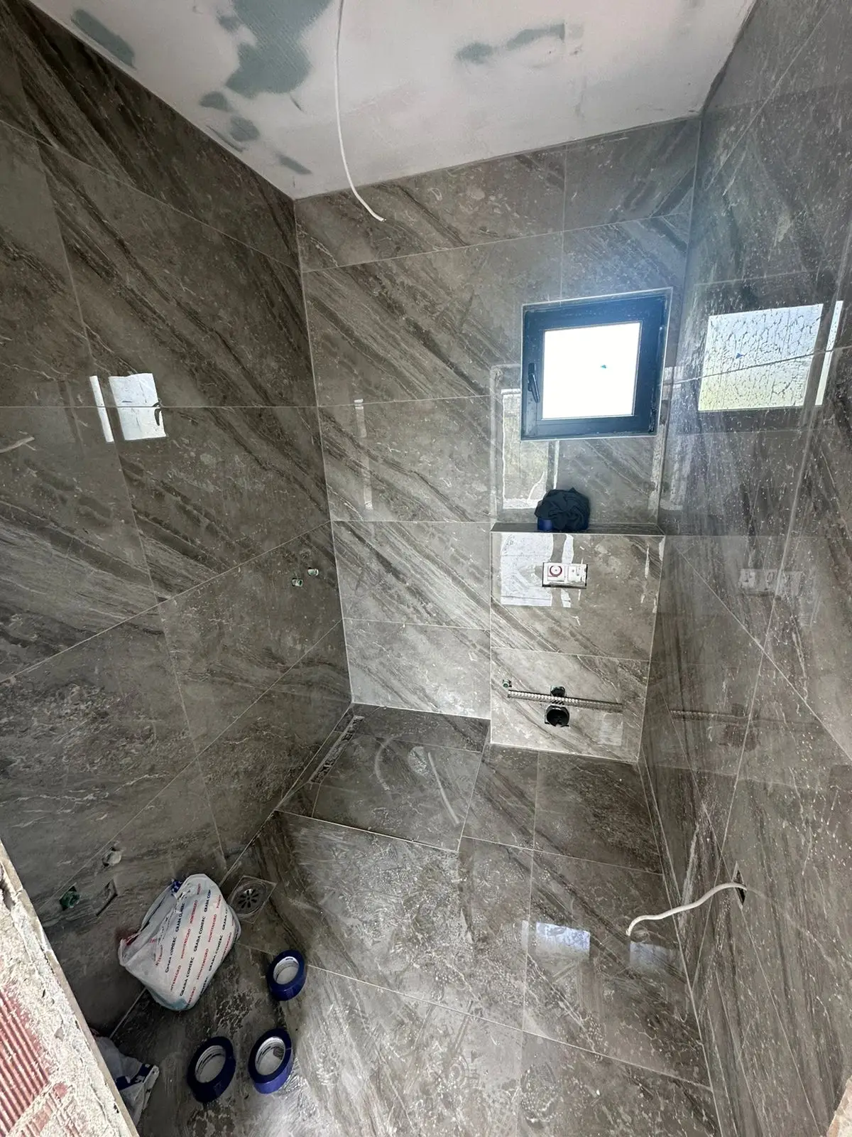 Bathroom under construction in Ulcinj with gray marble tiles&mdash;prime real estate investment via immorenta.me by Ekosphere Doo.
