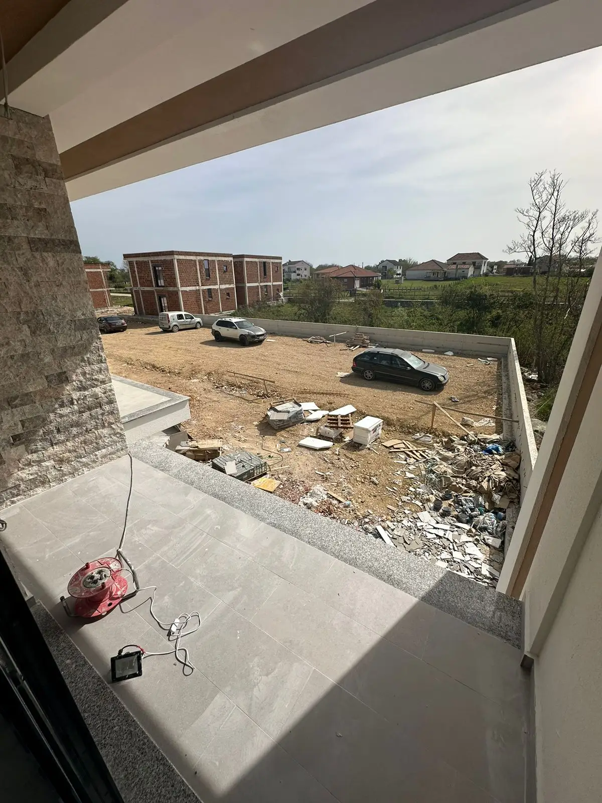 Prime investment opportunity in Ulcinj, Montenegro: balcony view of developing real estate, future homes, and growth. Powered by ekosphere doo.