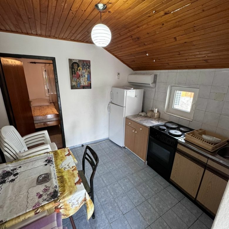 Charming Ulcinj kitchen with tiled floor, wood ceiling, dining area&mdash;ideal Montenegro investment by Ekosphere on immorenta.me.