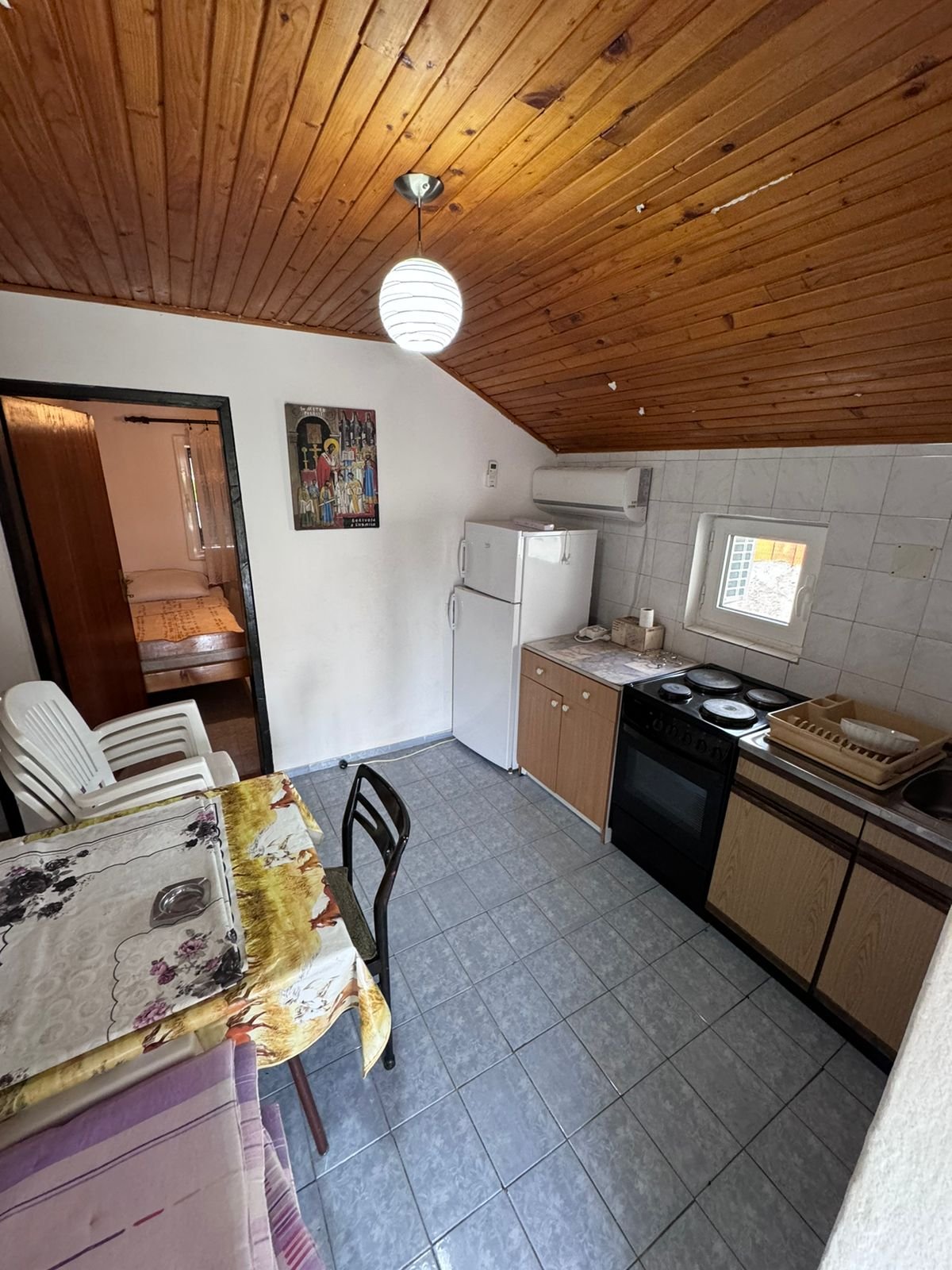Charming Ulcinj kitchen with tiled floor, wood ceiling, dining area&mdash;ideal Montenegro investment by Ekosphere on immorenta.me.