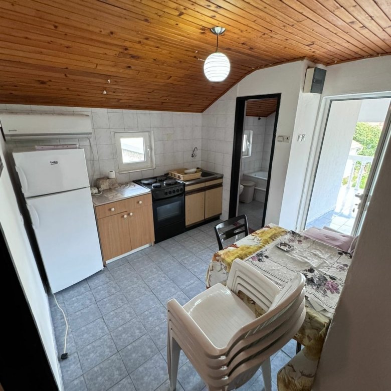Charming Ulcinj apartment: cozy kitchen & dining, wood ceiling, outdoor access. Prime investment on immorenta.me by ekosphere doo.