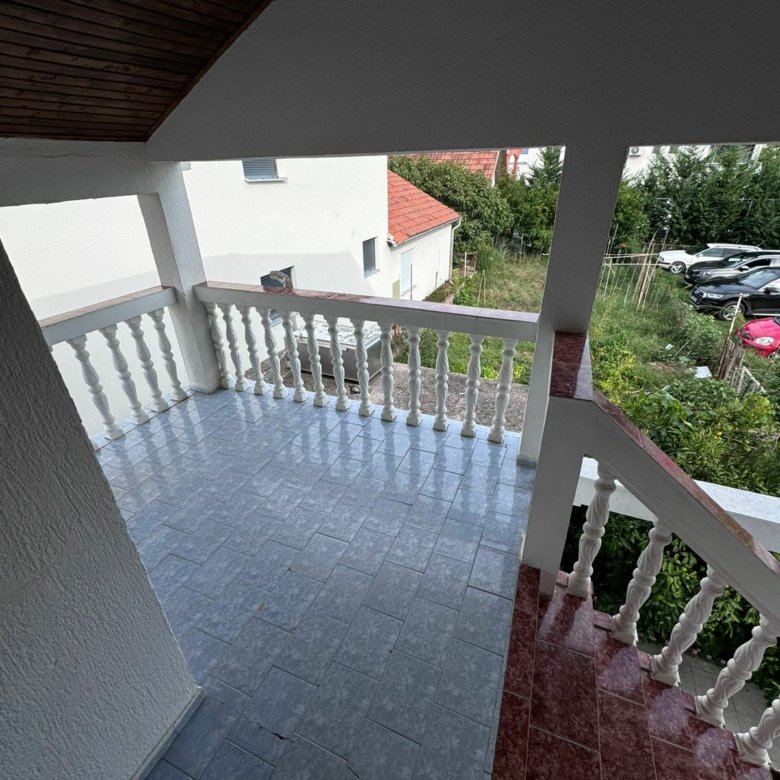 Inviting covered porch with blue tiles and white railings in Ulcinj&mdash;prime investment via immorenta.me by ekosphere doo.
