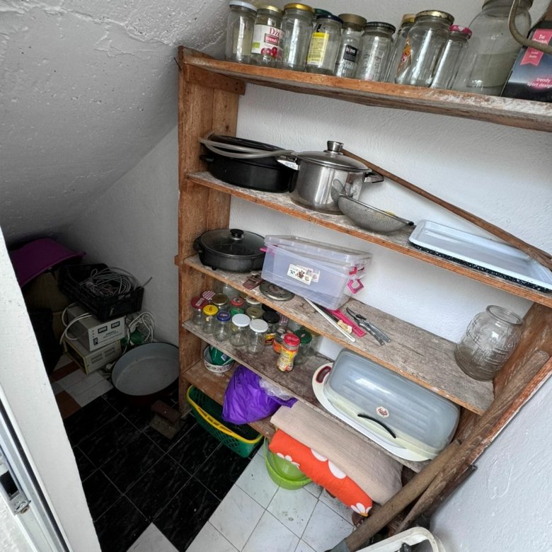 Charming Ulcinj pantry with wooden shelving, black-white tiled floor&mdash;ideal storage for investment homes. Montenegro-listings.me by ekosphere doo.