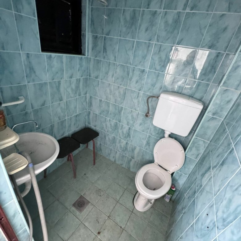 Modern Ulcinj bathroom with blue tiles, window, updated fixtures&mdash;invest in Montenegro property via immorenta.me by ekosphere doo.