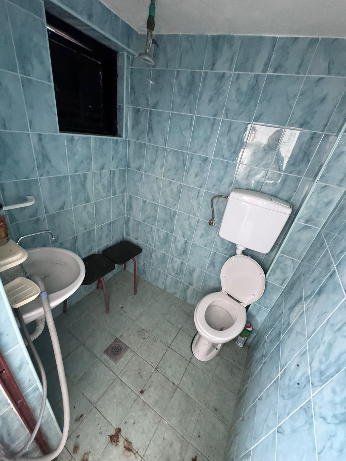 Modern Ulcinj bathroom with blue tiles, window, updated fixtures&mdash;invest in Montenegro property via immorenta.me by ekosphere doo.