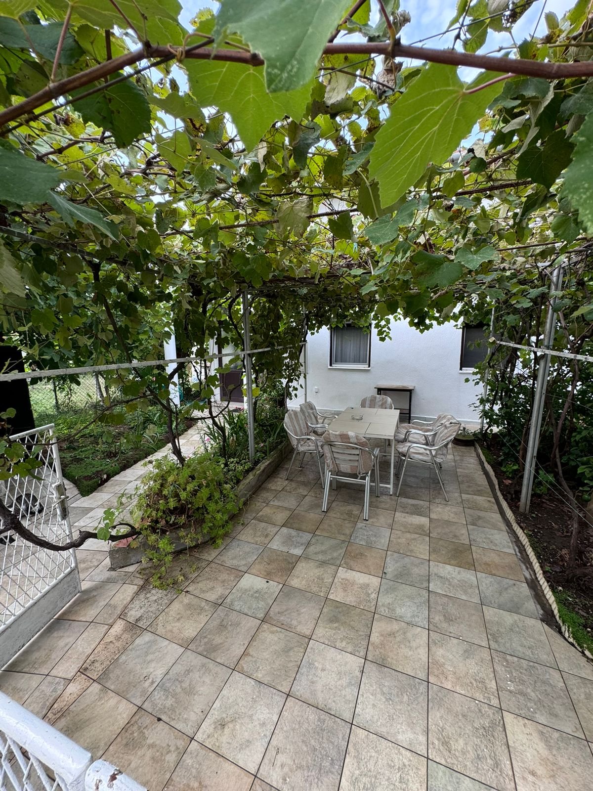 Stunning Ulcinj property: Tiled patio with grapevine pergola, ideal for investors. Exclusive at immorenta.me by ekosphere doo.