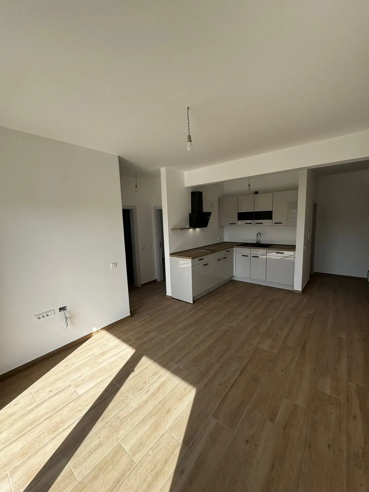 Bright, modern kitchen and living space with wood floors and built-in cabinets&mdash;ideal Ulcinj investment. Listed by ekosphere doo.