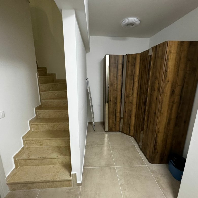 Modern hallway in Ulcinj property: beige tiles, sleek stairs, bright walls&mdash;exclusive at immorenta.me by ekosphere doo.