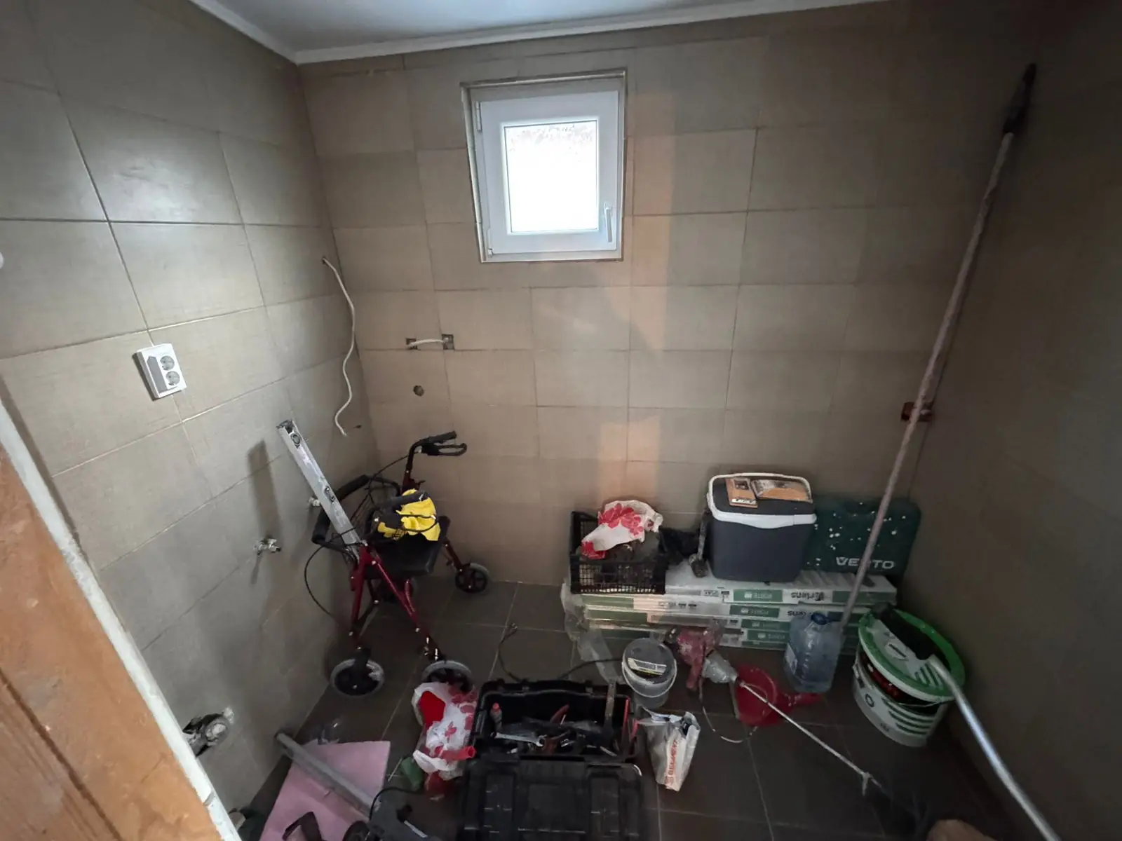 Renovation opportunity in Ulcinj, Montenegro: tiled room with window, tools; prime investment via immorenta.me by Ekosphere DOO.