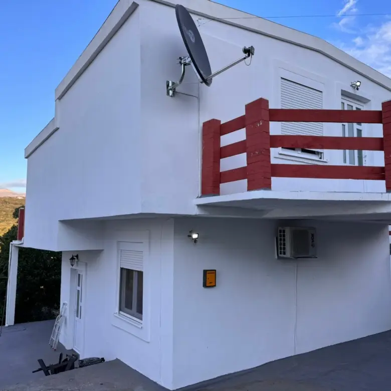 Stunning two-story white home in Ulcinj, Montenegro with red balconies&mdash;prime real estate investment via immorenta.me by ekosphere doo.