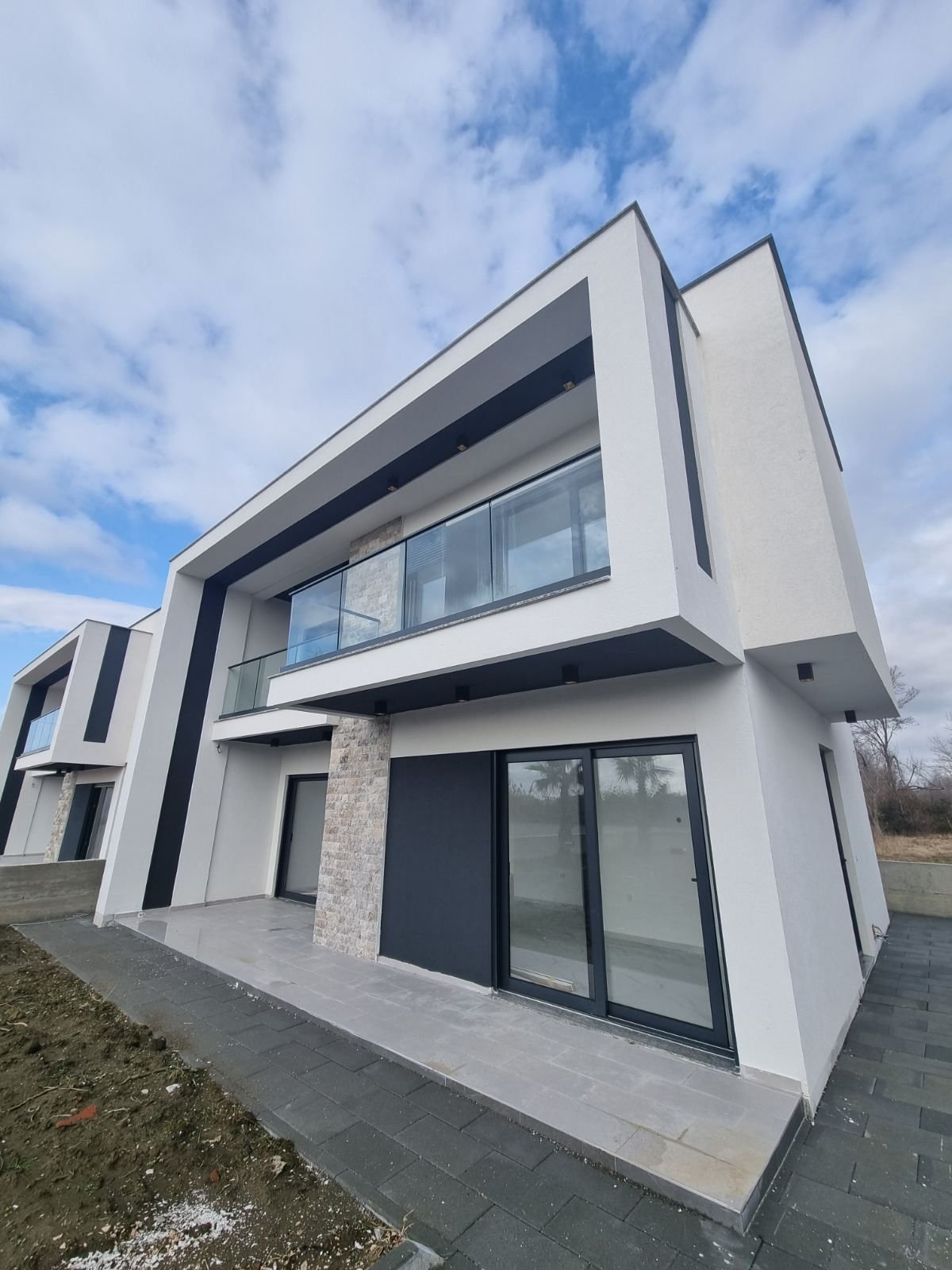 Stunning modern two-story home in Ulcinj with glass balcony, stone accents, and luxury finishes&mdash;exclusive by immorenta.me.