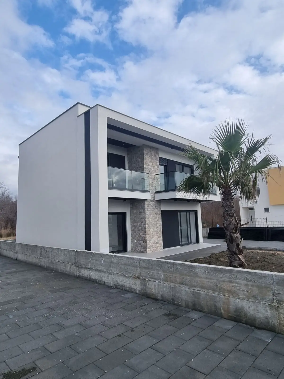 Luxury modern two-story home with glass balconies and stone accents in Ulcinj, Montenegro&mdash;prime investment via immorenta.me by ekosphere doo.