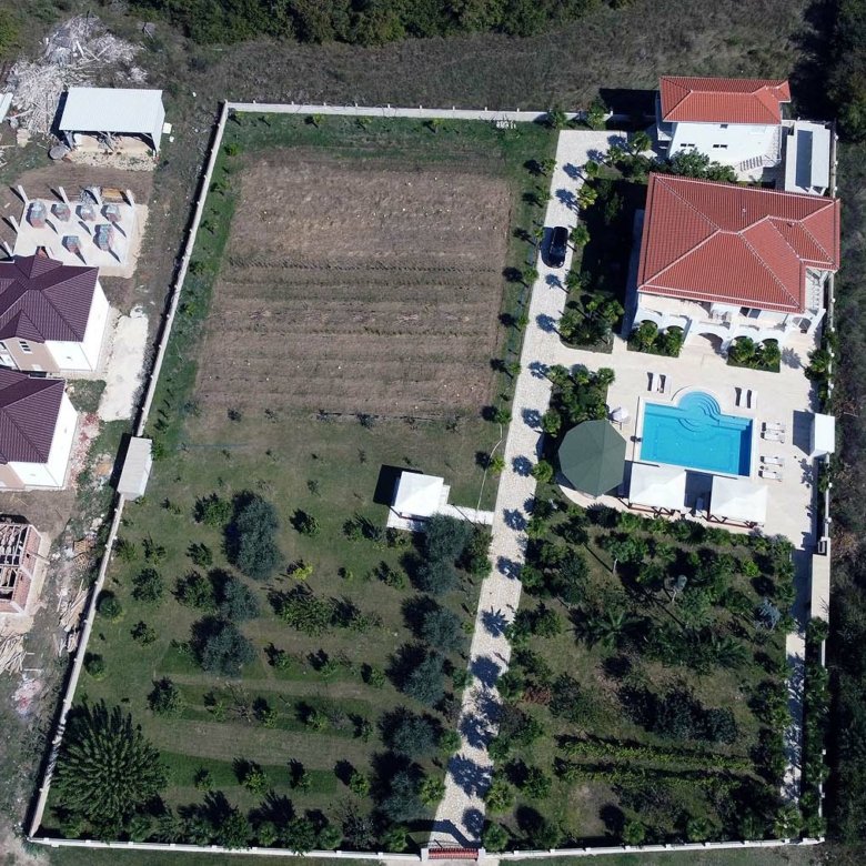 Stunning aerial view of gated Ulcinj property: two red-roof homes, pool, gardens&mdash;prime real estate by ekosphere doo, invest now!.