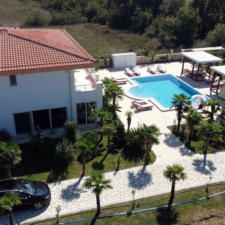 Aerial view of luxury Ulcinj villa for sale: red-tiled roof, pool, gazebo, palm-lined drive&mdash;exclusive at immorenta.me by ekosphere doo.