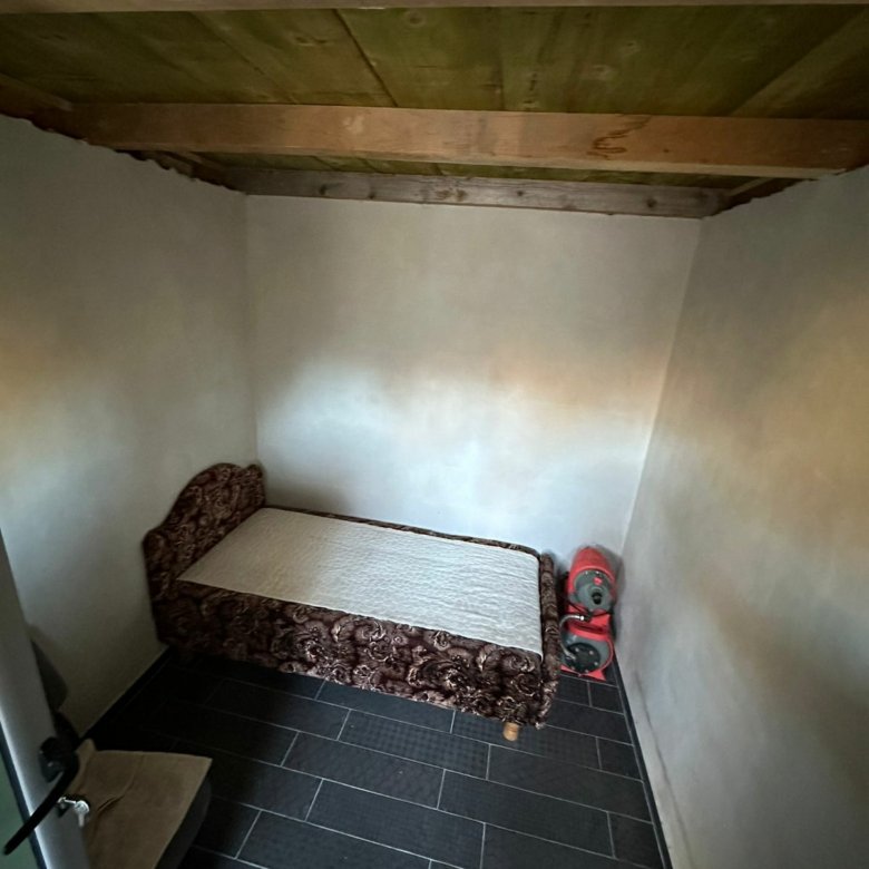 Charming Ulcinj property: sleek black-tiled floor, wooden ceiling, cozy bed&mdash;great Montenegro investment via immorenta.me.