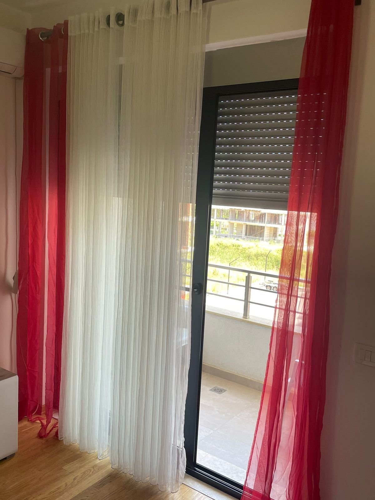 Sunlit glass door with metal shutter opens to balcony&mdash;ideal Ulcinj, Montenegro investment. Listed by immorenta.me, ekosphere doo.