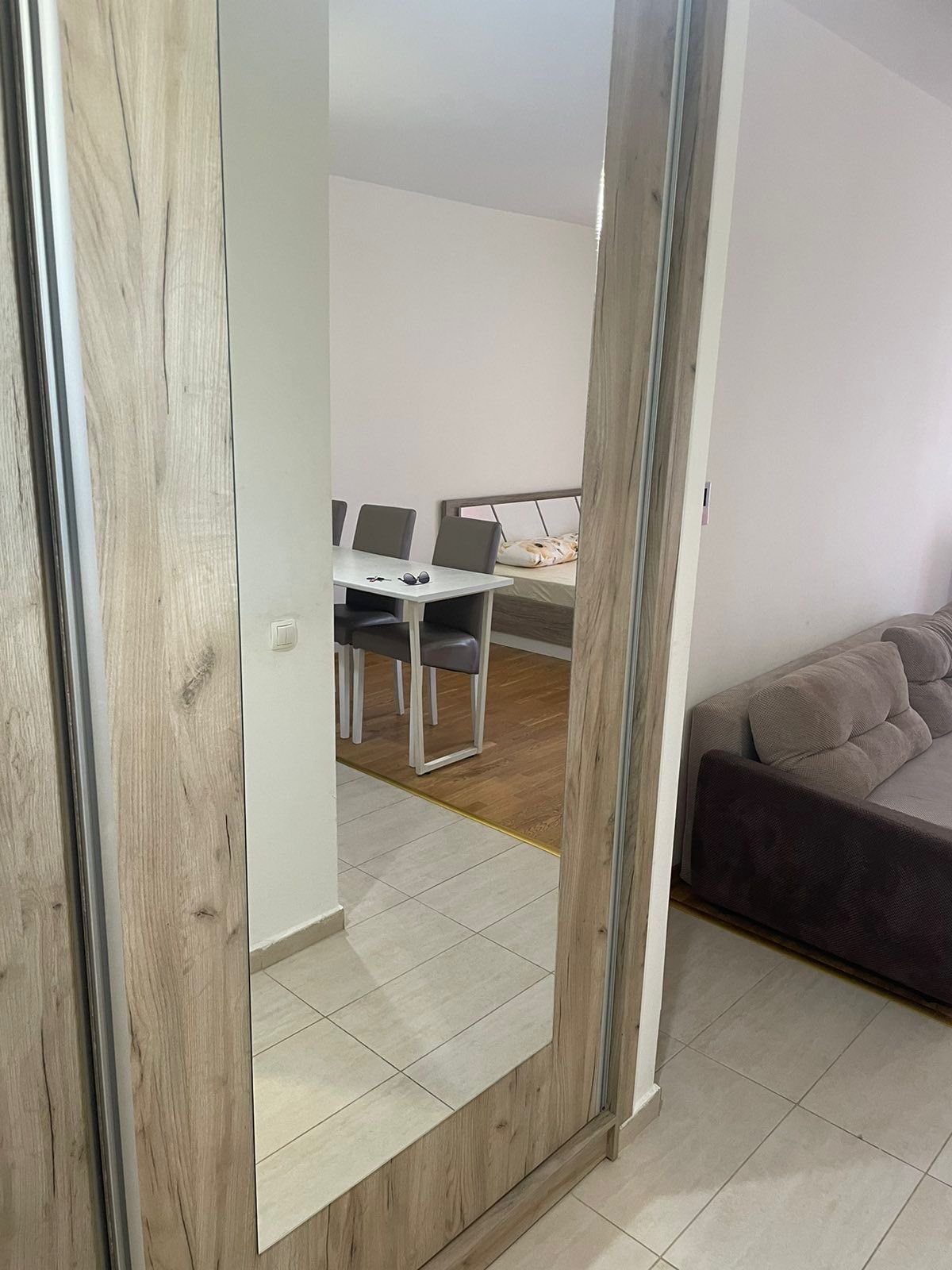 Stylish hallway in Ulcinj with mirrored wardrobe, dining area, and bed&mdash;ideal Montenegro real estate via ekosphere doo at immorenta.me.