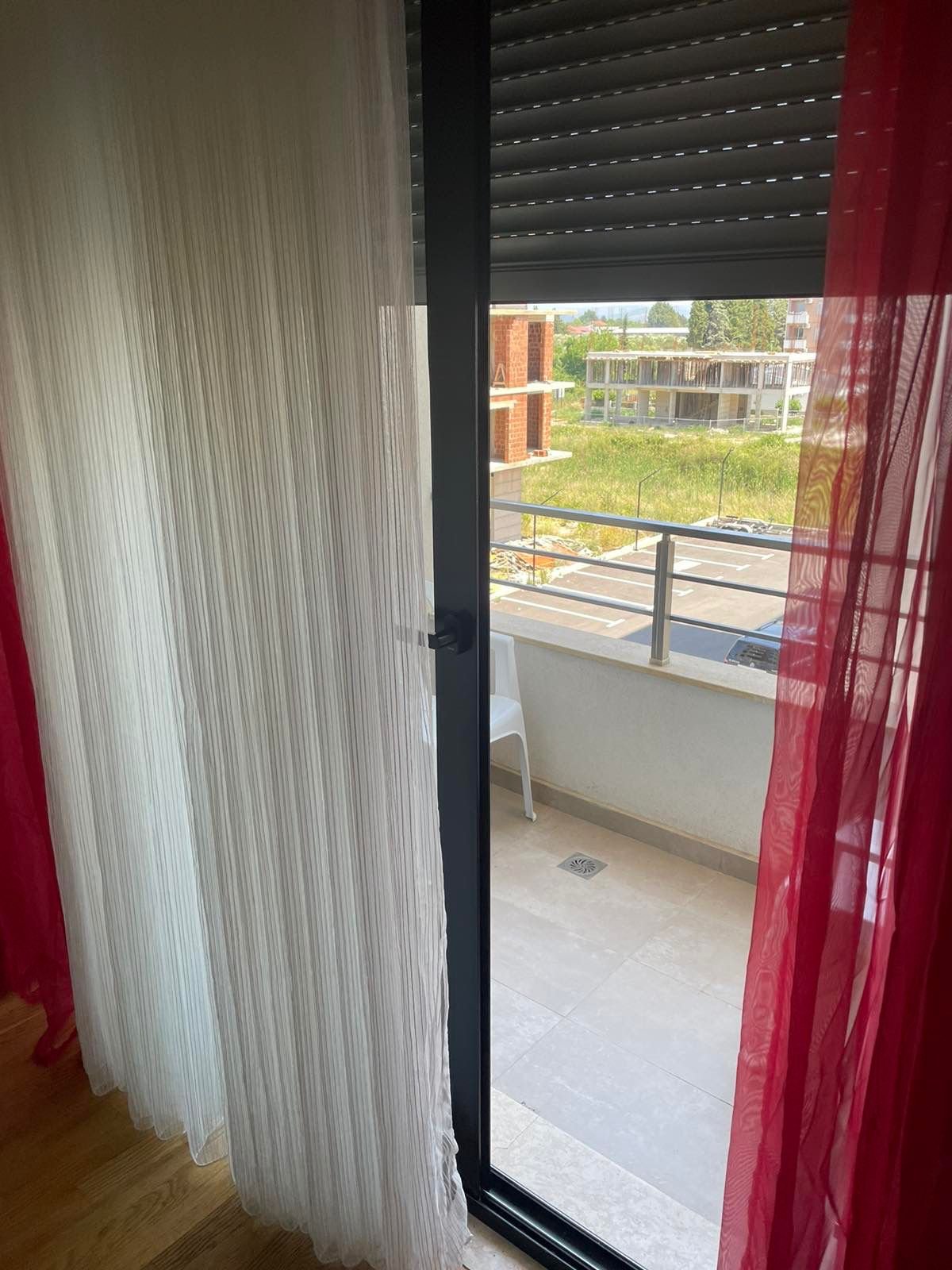Spacious Ulcinj apartment: balcony views, modern glass door, investment potential near amenities. Listed by immorenta.me (ekosphere doo).