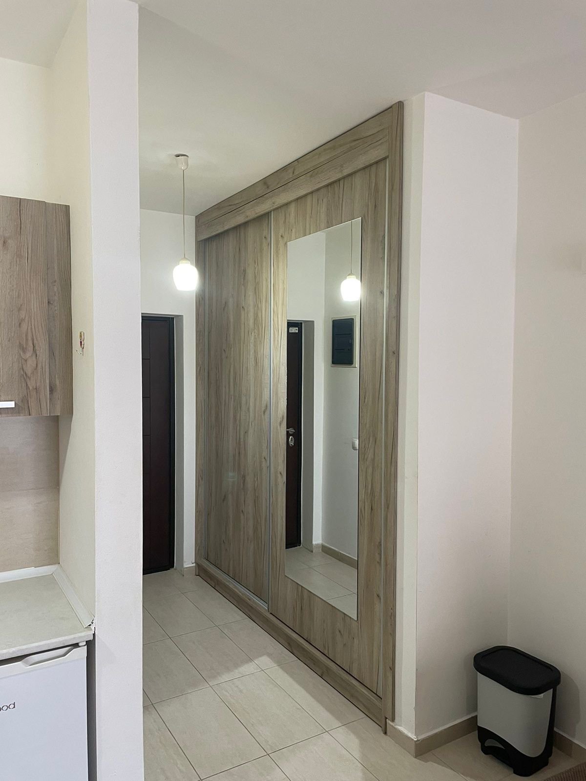 Modern hallway in Ulcinj, Montenegro with beige tiles, mirrored wardrobe, and quality finishes&mdash;exclusive on immorenta.me by ekosphere doo.