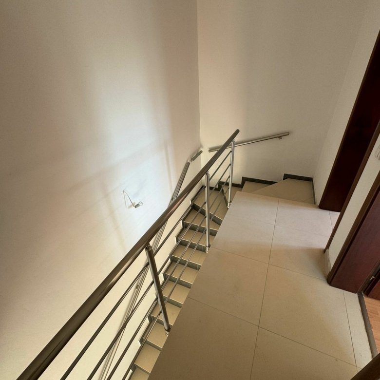 Modern staircase with metal railings, tiled steps, and light floors in Ulcinj&mdash;exclusive property by immorenta.me, ekosphere doo.