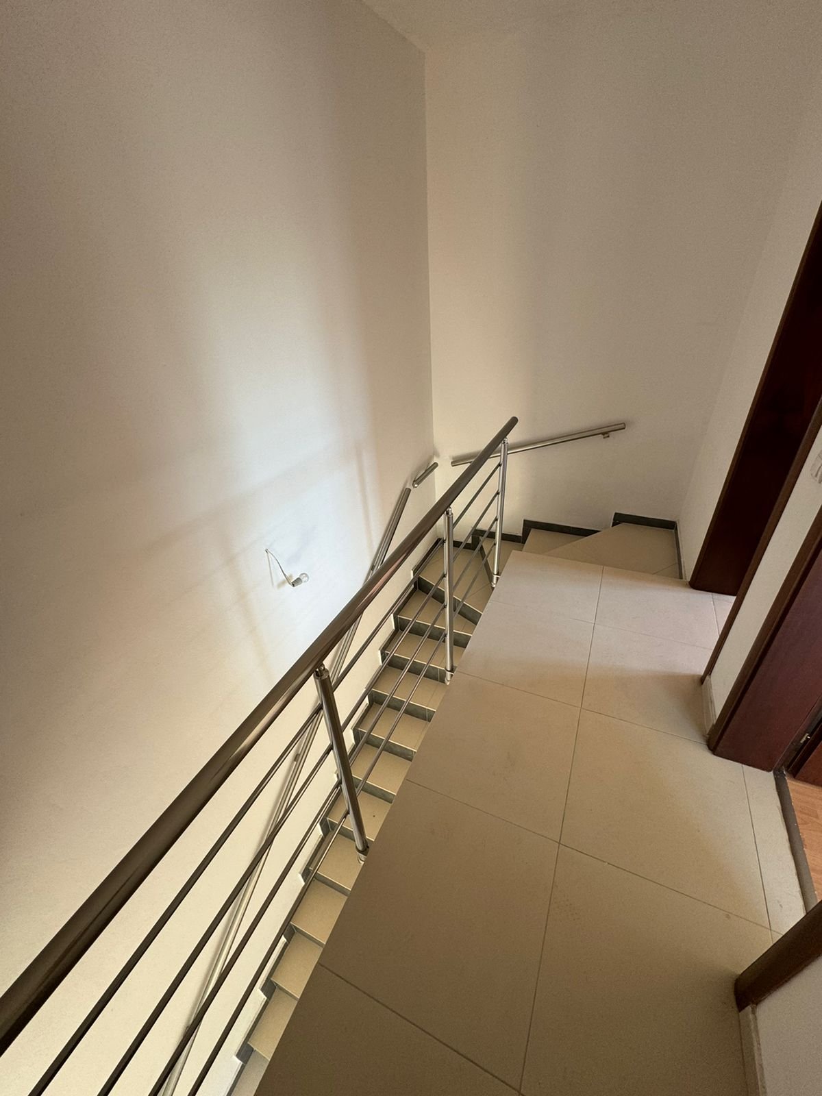 Modern staircase with metal railings, tiled steps, and light floors in Ulcinj&mdash;exclusive property by immorenta.me, ekosphere doo.