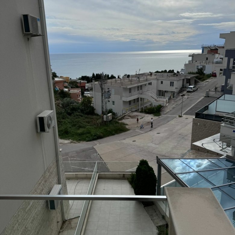 Discover premium Ulcinj real estate: balcony with sea view, lush greenery, white homes. Invest via immorenta.me by Ekosphere d.o.o.