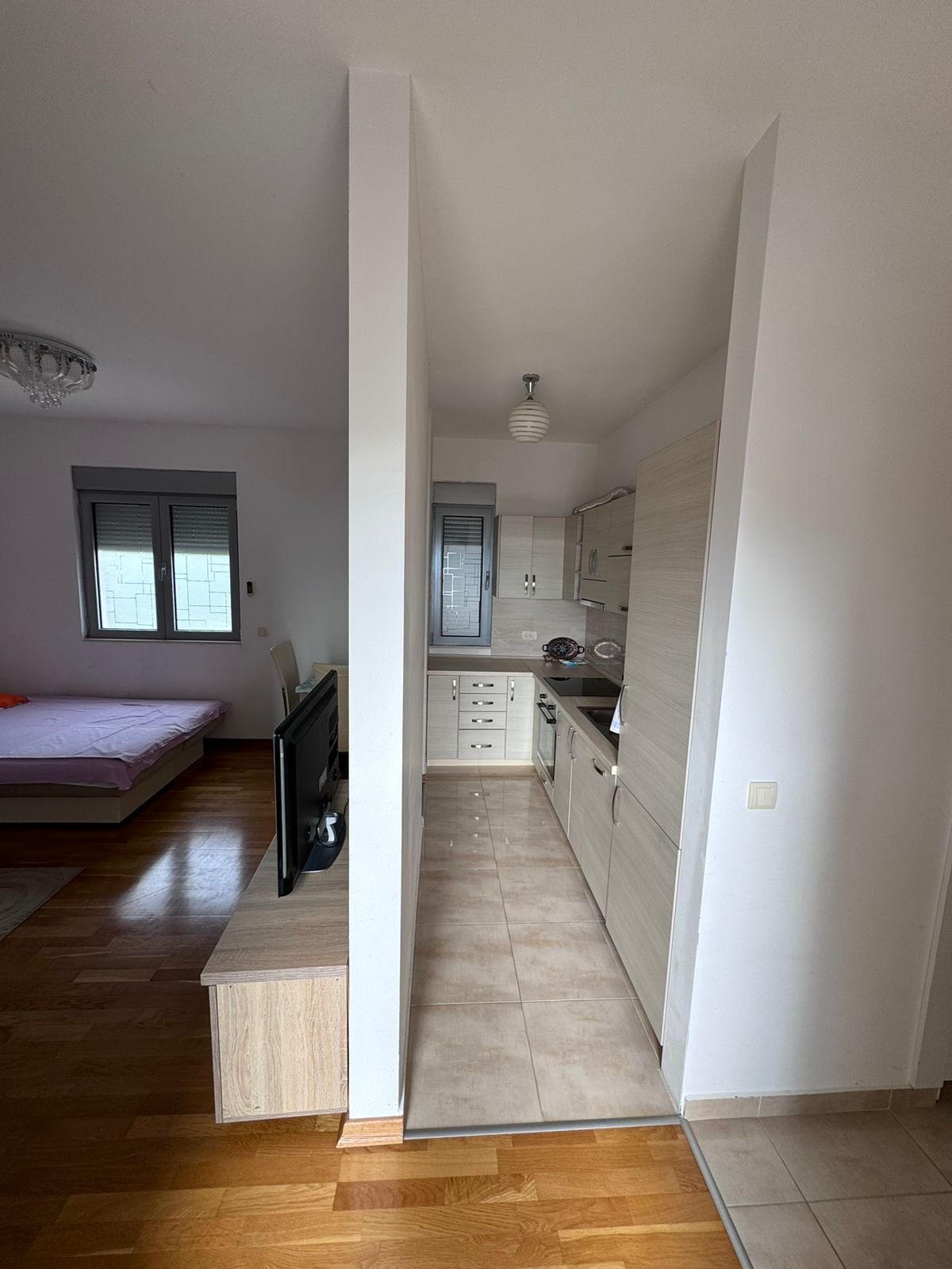 Modern Ulcinj apartment: cozy double bedroom, compact kitchen, smart layout ideal for investment. Listed on immorenta.me by ekosphere doo.