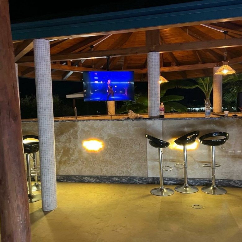 Stunning outdoor bar with tiled counter and TV, under elegant beams&mdash;exclusive Ulcinj real estate at immorenta.me by Ekosphere.