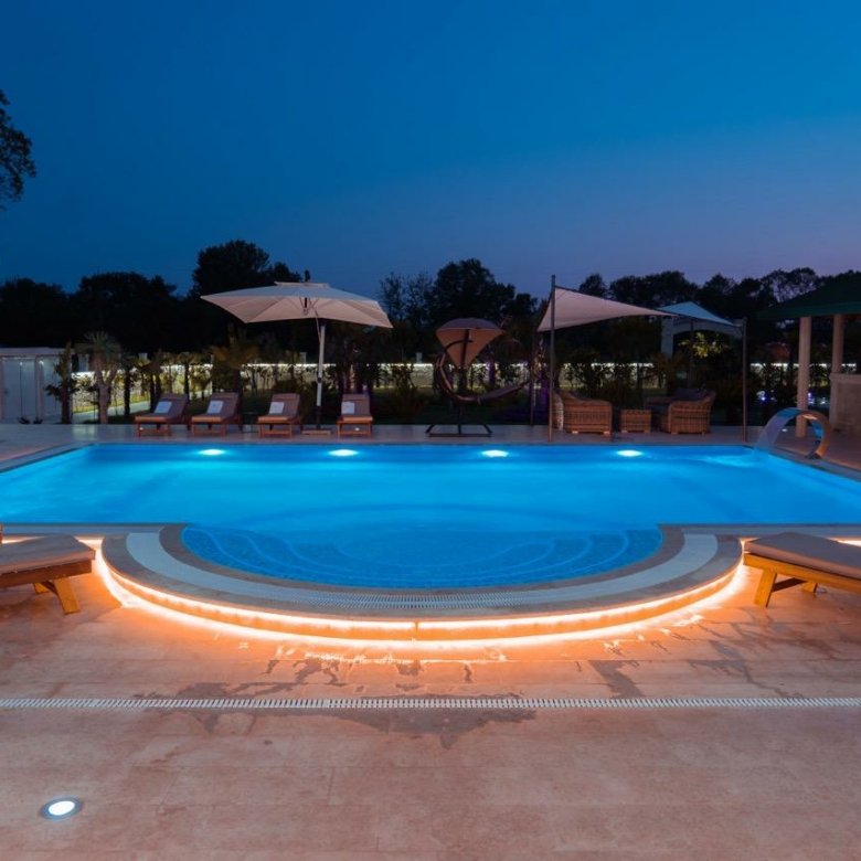 Luxury Ulcinj property: night-lit pool, elegant loungers, lush trees&mdash;prime investment on Montenegro-Listings.me by Ekosphere doo.