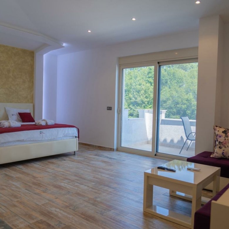 Luxurious Ulcinj hotel room with modern finishes, double bed, chic lounge, balcony&mdash;exclusive on immorenta.me by ekosphere.