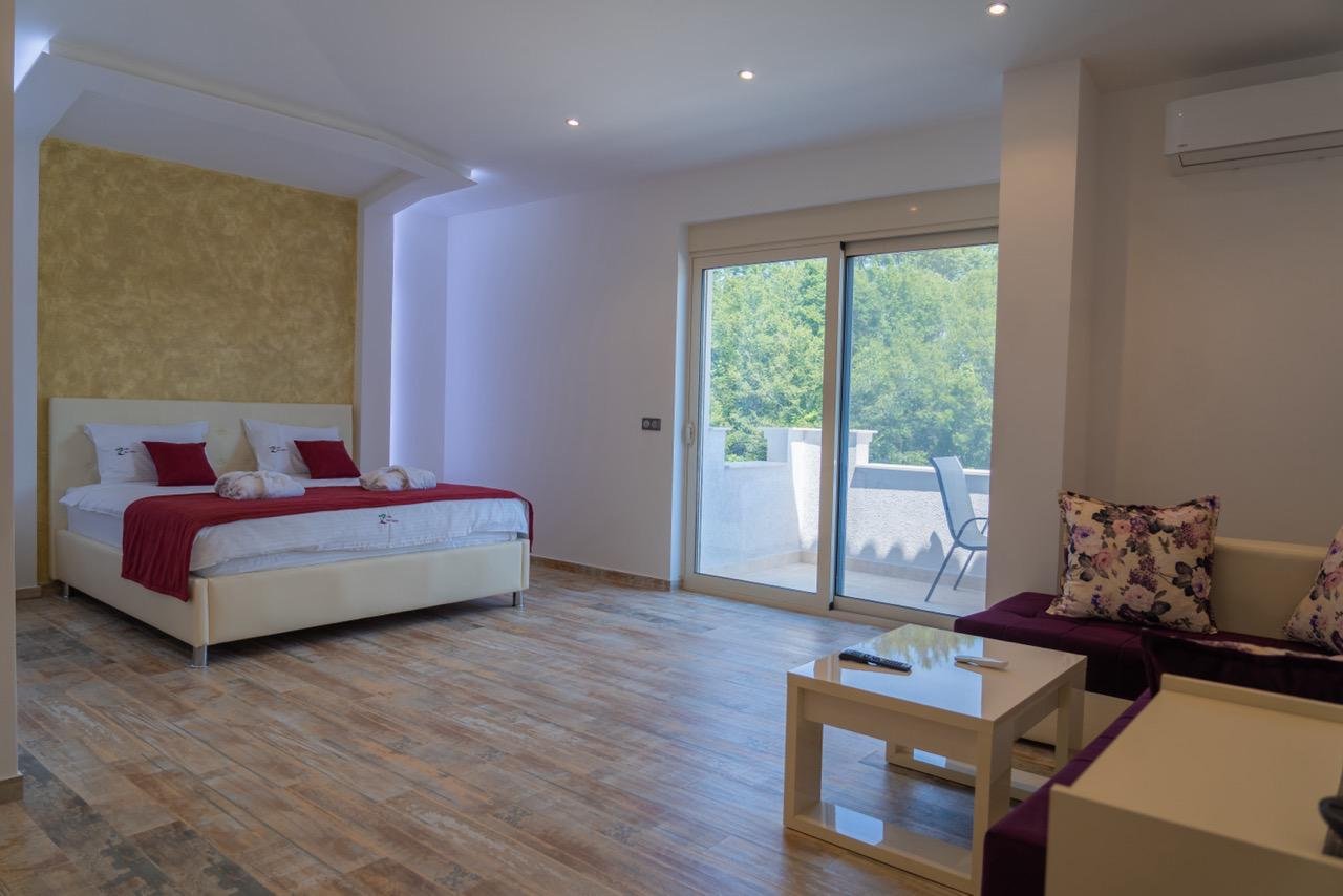 Luxurious Ulcinj hotel room with modern finishes, double bed, chic lounge, balcony&mdash;exclusive on immorenta.me by ekosphere.