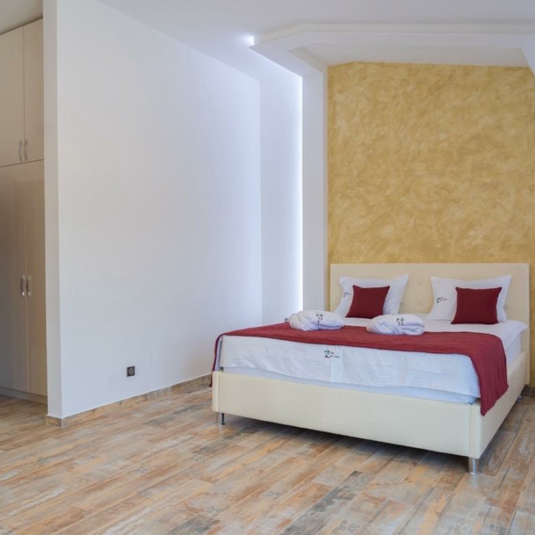 Elegant modern bedroom in Ulcinj with double bed, sleek finishes, open closet&mdash;ideal Montenegro investment. Montenegro-listings.me by Ekosphere.