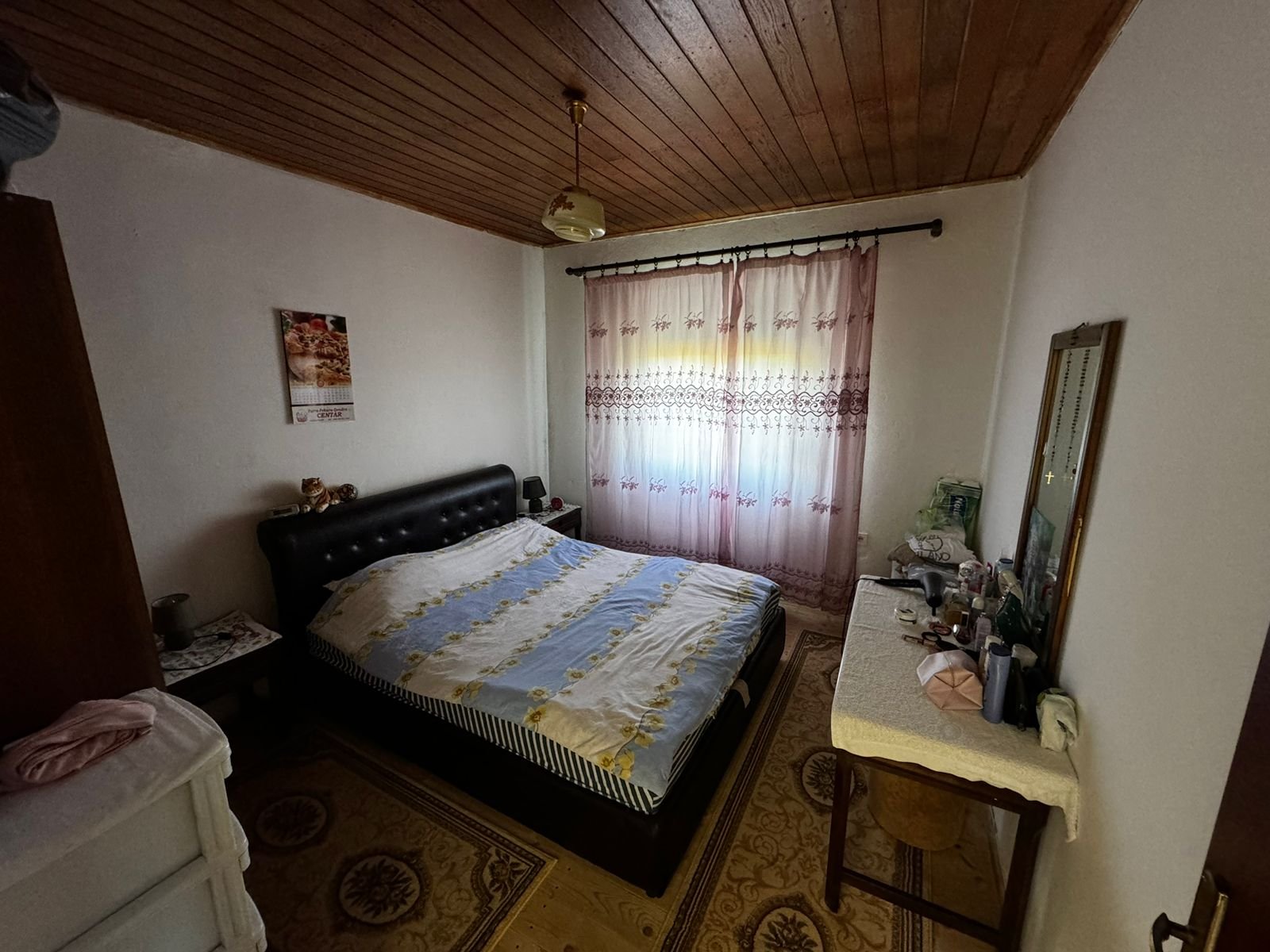 Charming Ulcinj bedroom with double bed, wood ceiling, pink curtains&mdash;ideal Montenegro real estate by ekosphere doo on immorenta.me.
