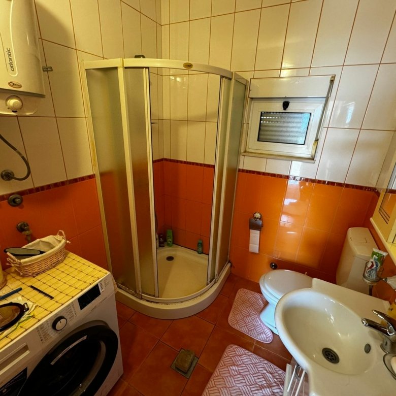 Modern Ulcinj bathroom with vibrant tiling, shower, bidet, washer&mdash;exclusive on immorenta.me by ekosphere doo.