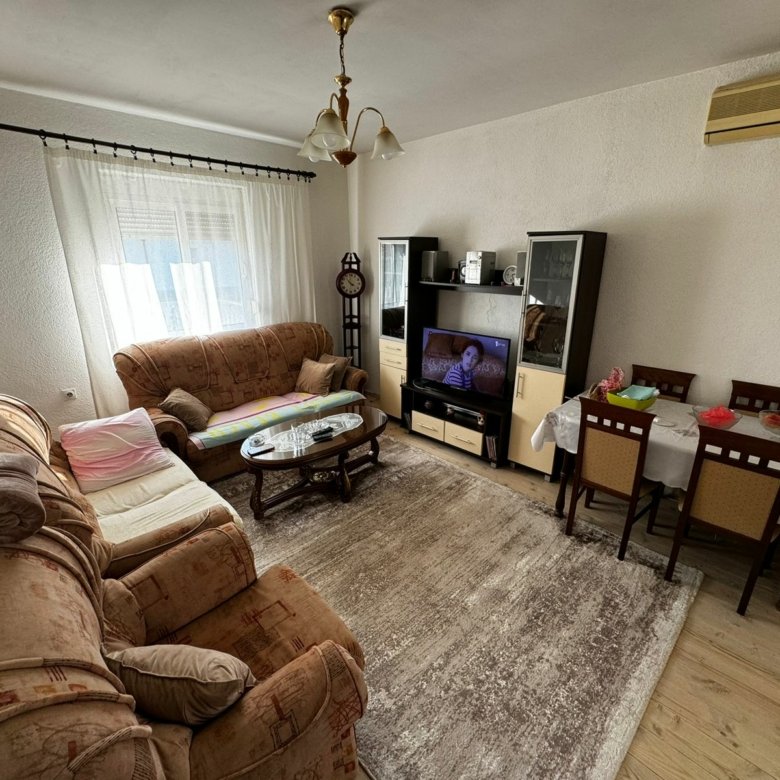 Elegant Ulcinj living room: two brown sofas, glass table, TV, dining for six. Prime property from ekosphere doo at immorenta.me.