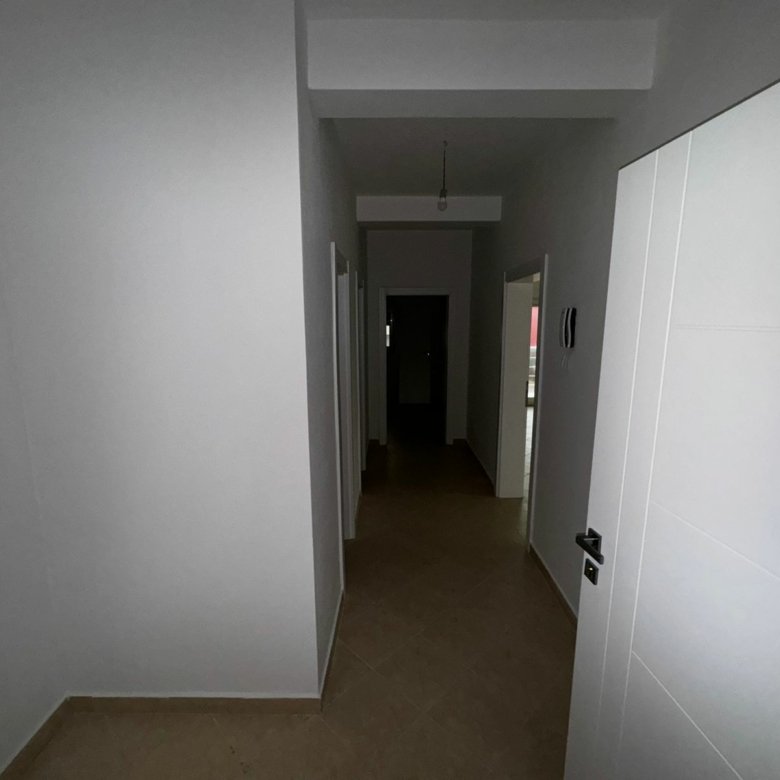 Spacious hallway with white walls, beige tile floors, and multiple doors&mdash;ideal Ulcinj property by ekosphere doo on immorenta.me.