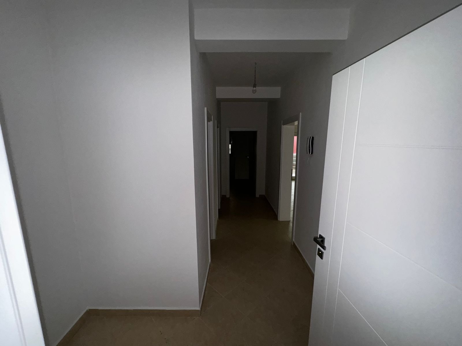 Spacious hallway with white walls, beige tile floors, and multiple doors&mdash;ideal Ulcinj property by ekosphere doo on immorenta.me.