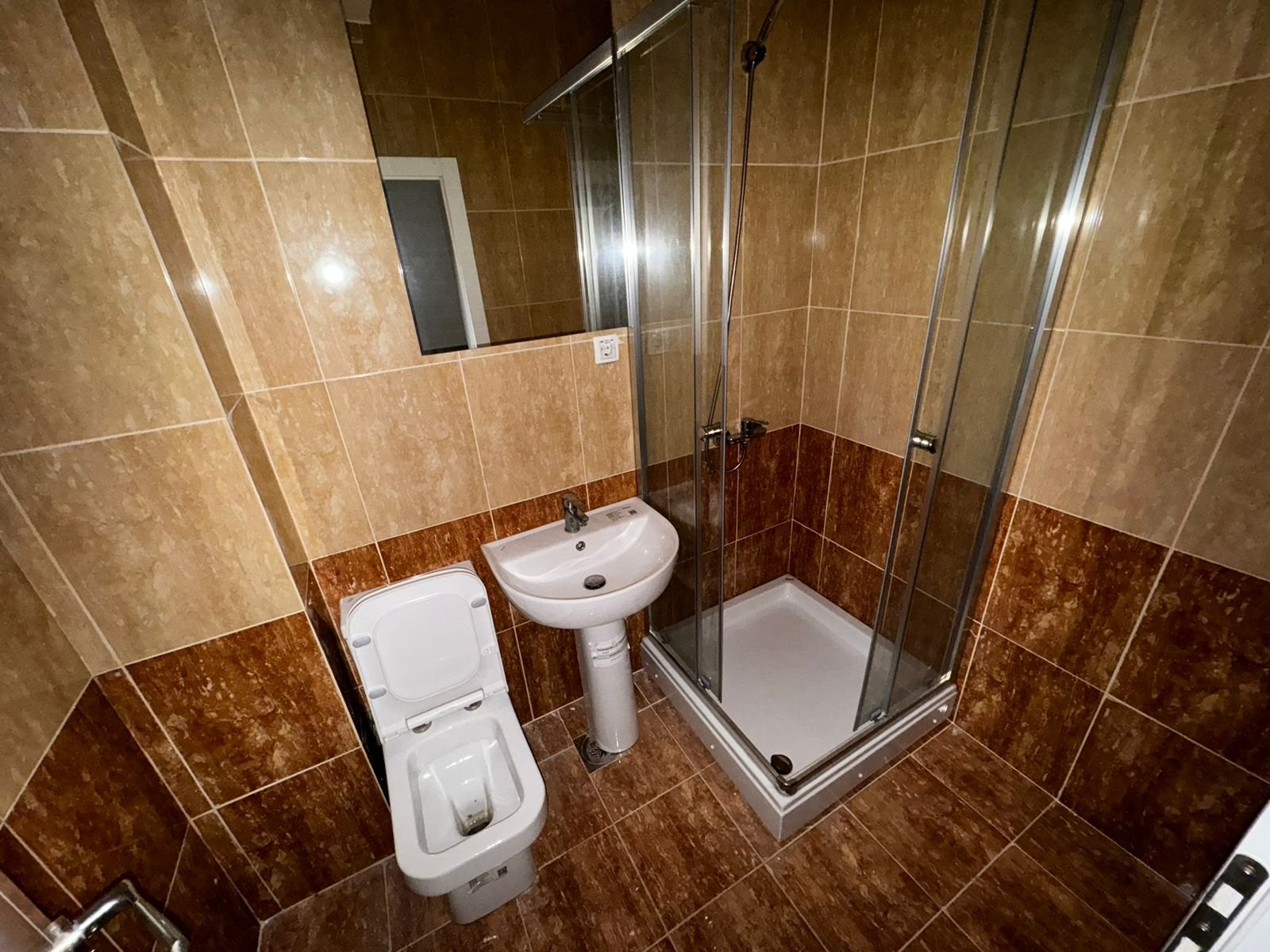 Modern Ulcinj bathroom with stylish tiles, glass shower, and quality fixtures. Exclusive at immorenta.me by ekosphere doo.