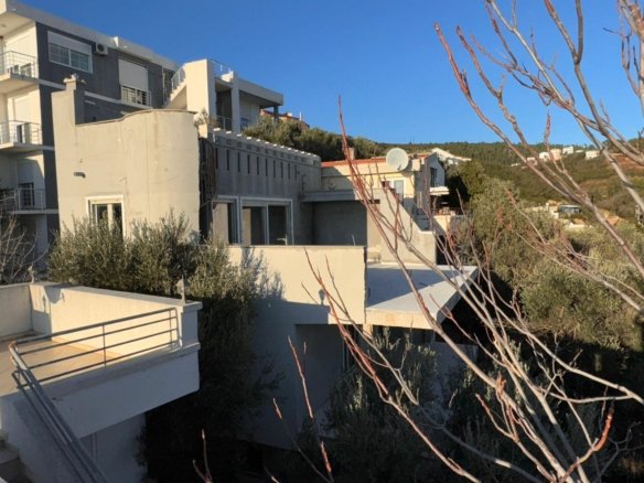 Luxury multi-story grey and white building with balconies in Ulcinj, Montenegro&mdash;prime real estate by immorenta.me.