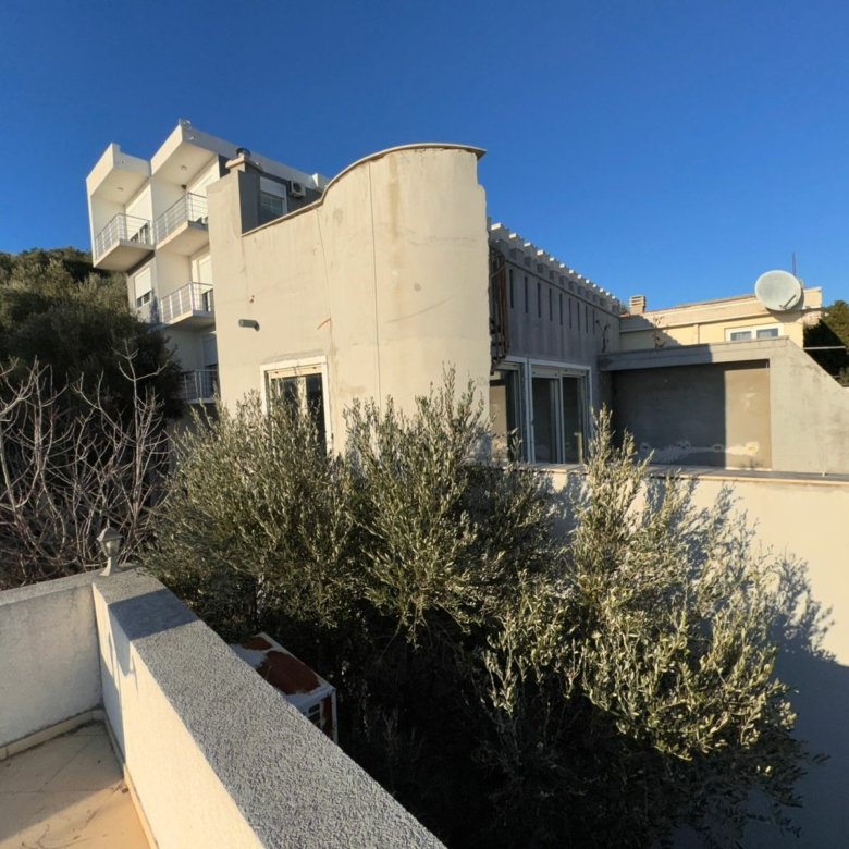 Contemporary light-grey building with balconies and large windows in Ulcinj, Montenegro&mdash;prime real estate by immorenta.me.