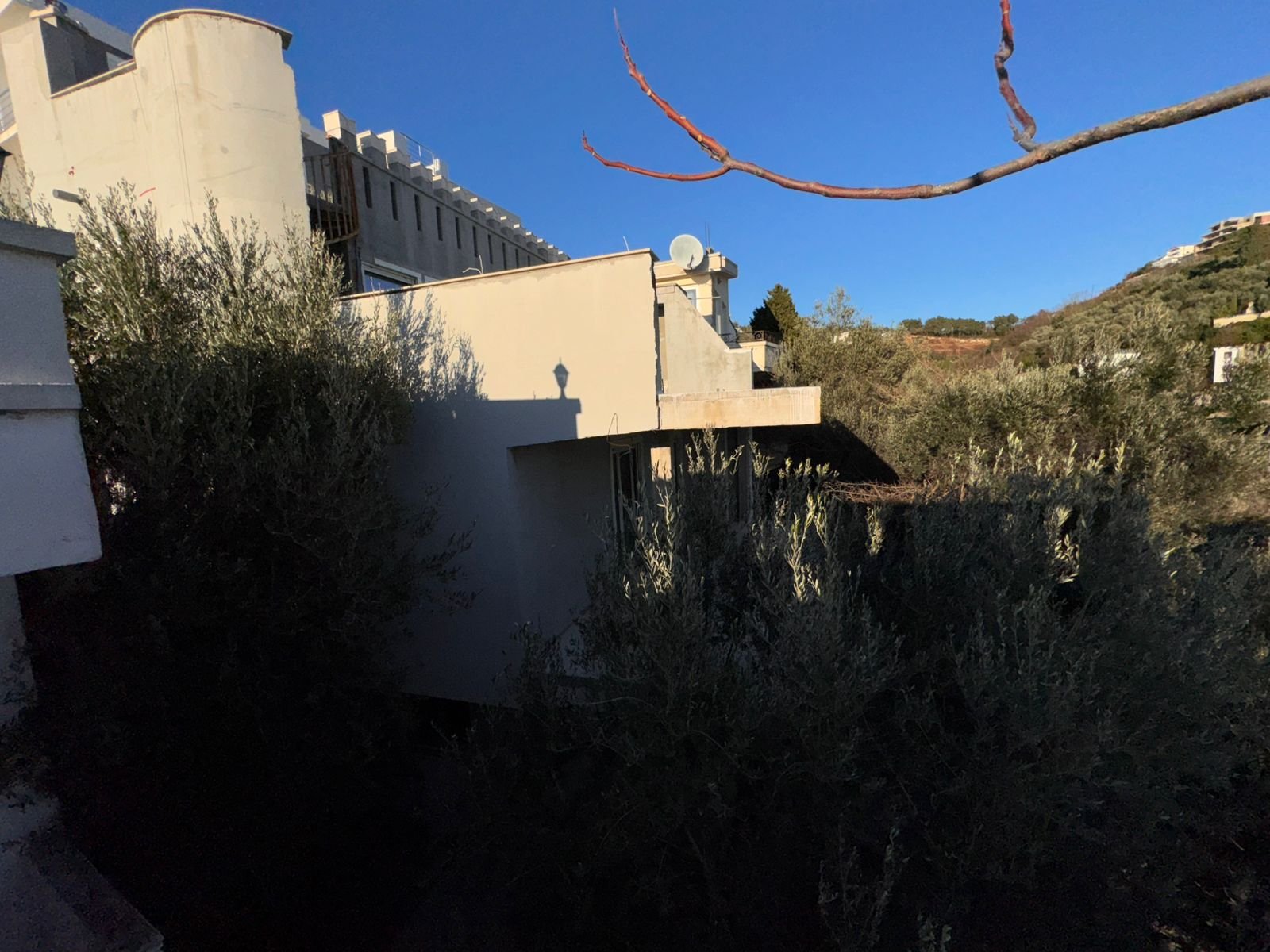 Modern white property for sale in Ulcinj, Montenegro, by Ekosphere DOO. Sunny roof with satellite dishes, clear sky&mdash;exclusive listing.