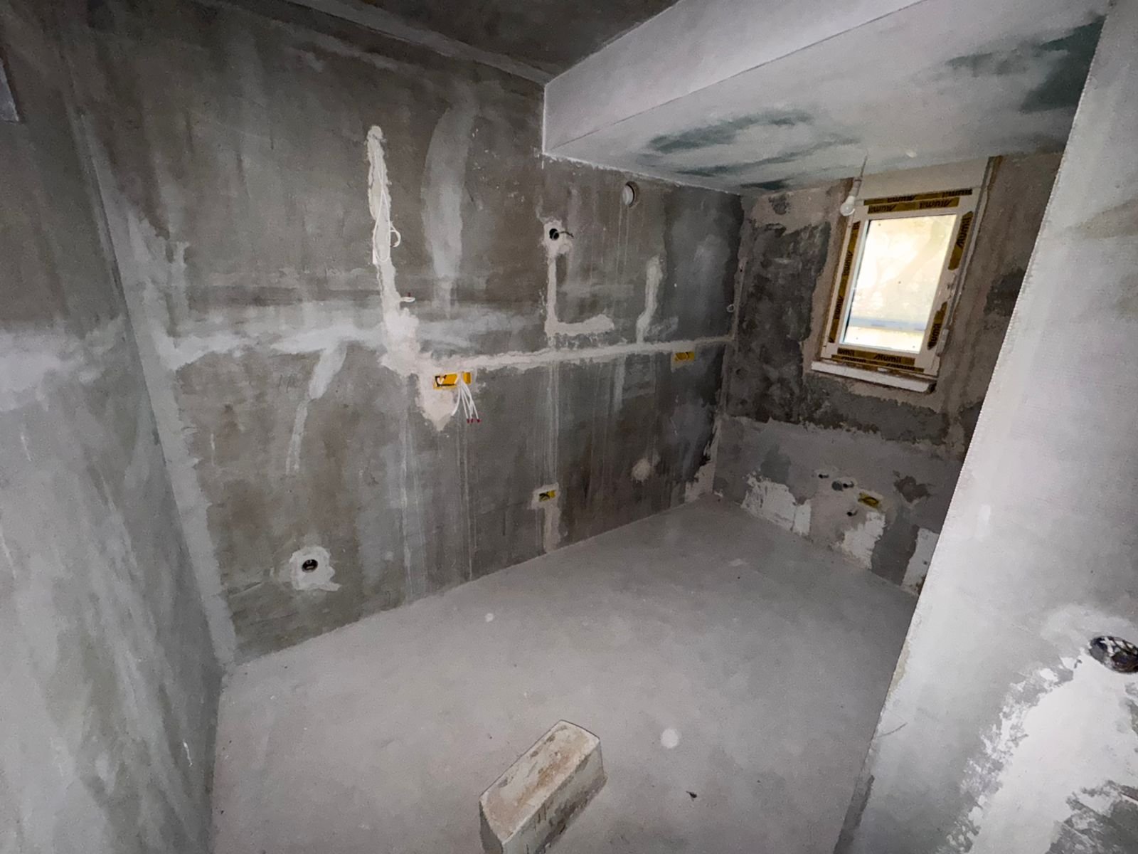Spacious unfinished concrete room with utility points, large window, and investment potential in Ulcinj&mdash;exclusive at immorenta.me by Ekosphere doo.