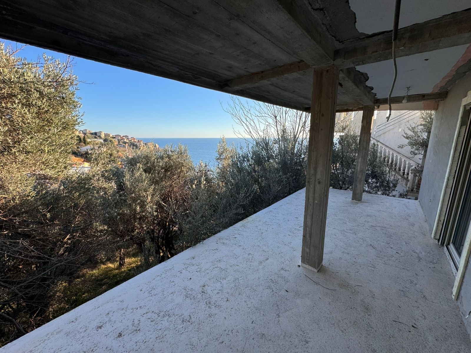 Stunning concrete balcony with wooden beams, sea views, and townscape&mdash;prime Ulcinj property on immorenta.me by Ekosphere Doo.