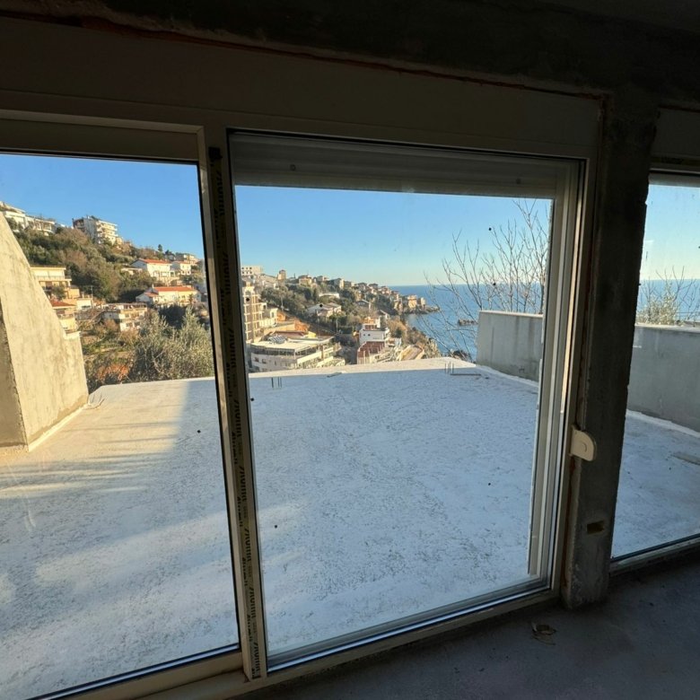 Modern three-glass-door view to terrace, sea, and hillside homes in Ulcinj, Montenegro&mdash;premium property by Ekosphere on immorenta.me.