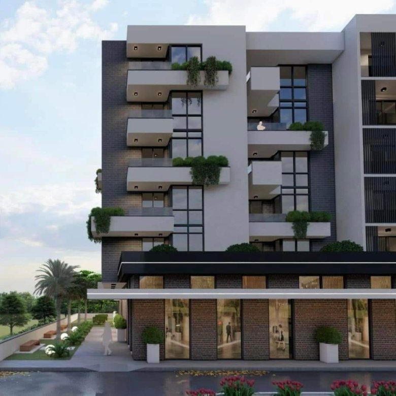 Contemporary multi-story building in Ulcinj with glass balconies, large windows, and premium storefronts&mdash;invest with ekosphere doo.